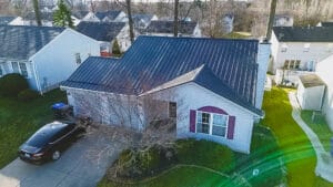 Expert metal roofing team installing alpha rib metal roof panels on Akron residential property