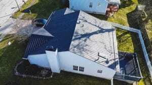 Expert metal roofers installing impact-resistant standing seam metal roof on Akron property