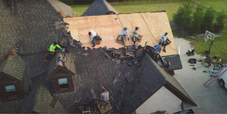 The-crew-from-Eagle-Eye-Roofing-LLC-tearing-off-roof-shingles.