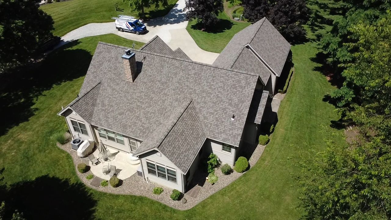 Eagle Eye Roofing crew installing asphalt shingles on a suburban home roof
